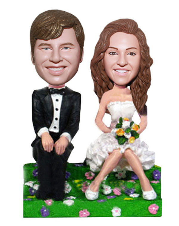 Groom And Bride Sitting On The Grass Bobbleheads Wedding